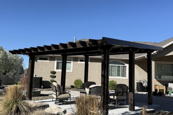 Decorative pergola-style patio cover with dark posts and open beam design