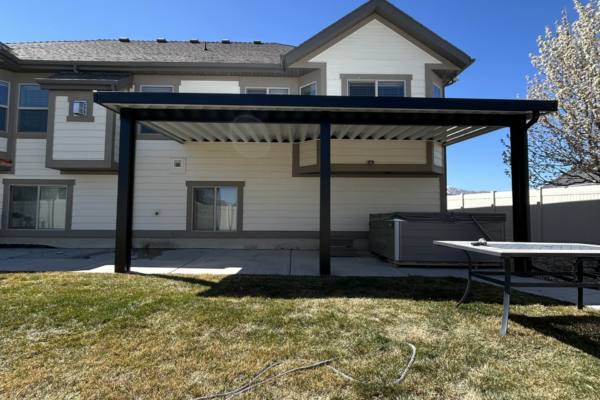 Custom metal patio cover installed in a backyard, providing shade and weather protection for outdoor living